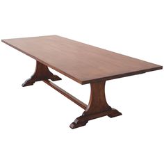 a large wooden table with two legs and a long rectangular dining table in the middle