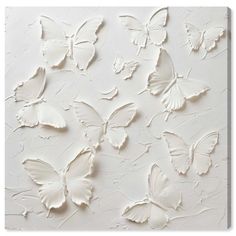 white butterflies painted on a wall in an art gallery, with the background textured to look like paint