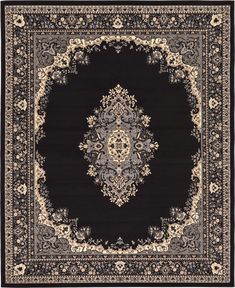 a black rug with an ornate design on the center and bottom border, in various colors