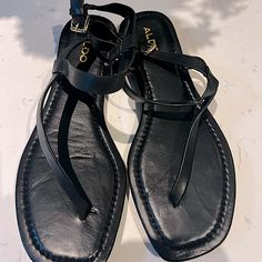 Black Leather Strap Aldo Sandals Size 8 - Never Worn Casual Black T-strap Sandals For Vacation, Chic Black Toe Post T-strap Sandals, Black T-strap Sandals With Ankle Strap For Vacation, Black T-strap Sandals For Vacation, Black Ankle Strap Flip Flops For Spring, Black T-strap Toe Post Sandals For Vacation, Black T-strap Sandals For Spring, Black Toe Post T-strap Sandals For Vacation, Chic Black Flip Flops With Single Toe Strap