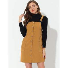 This dress is so versatile and can be worn over tops, shirts, or sweaters to create a charming look. It's perfect for weekdays at work, date nights, shopping trips, and daily life. You can style it with boots for a ready-to-go look. The dress features a simple and classic design with an above-knee length and a-line silhouette. It also has adjustable shoulder straps, two front pockets, a button-down closure, and a suspender dress. Casual Fall Pinafore Dress For Workwear, Casual Pinafore Dress For Work, Casual Long Sleeve Pinafore Dress, Casual Brown Pinafore Dress For Fall, Casual Fall Pinafore Dress, Pinafore Dress With Buttons For Workwear, Spring Workwear Pinafore Dress With Buttons, Casual Workwear Pinafore Dress With Buttons, Casual Pinafore Dress For Work With Buttons