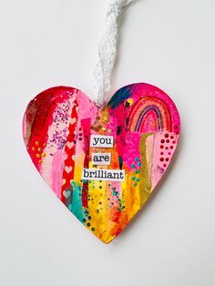 a heart shaped ornament that says, you are brilliant on it's side