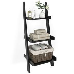 three tiered shelf with towels and other items on it, against a white background