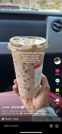 someone holding up a cup of coffee with sprinkles on it and the text, you're a dunkin girl now