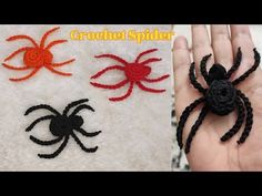 crochet spider and hand made spider on white towel with red, black and orange colors