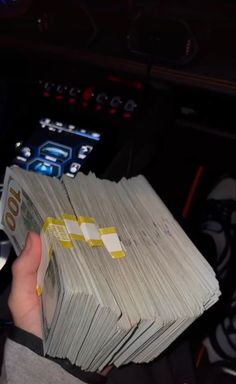 a person holding stacks of cash in their hand