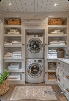 a washer and dryer in a room with lots of white linens on the shelves