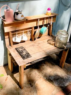 a wooden bench with pots and pans on it