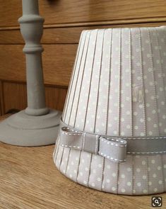 a lamp shade sitting on top of a wooden table