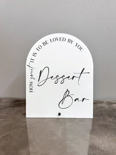 a sign that says how it's not loved by you desert bar on top of a table