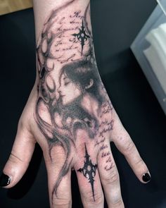 a woman's hand with a tattoo on it