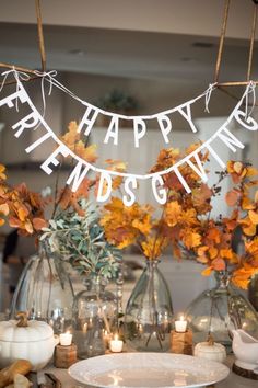 a table with candles and flowers in vases on top of it that says happy end s day