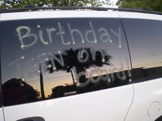 a white van with the words happy birthday on it's side window and palm trees in the background