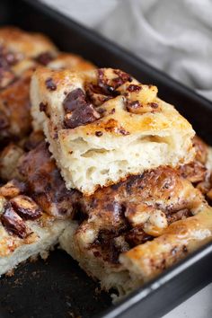 some food that is in a pan on a table and has been cut into pieces