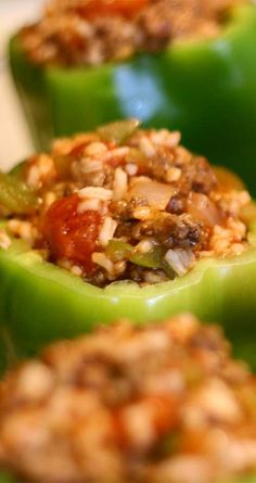 green peppers stuffed with meat and vegetables sitting on a counter top, ready to be eaten