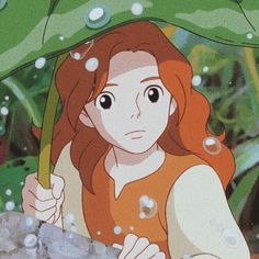 a girl holding an umbrella in the rain with water droplets on her face and hands