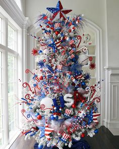 a decorated christmas tree with red, white and blue decorations