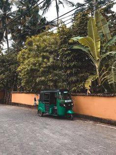 an electric scooter parked on the side of a road next to a wall