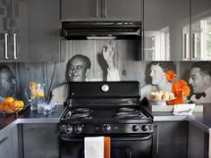 a black stove top oven sitting in a kitchen next to a wall with pictures on it