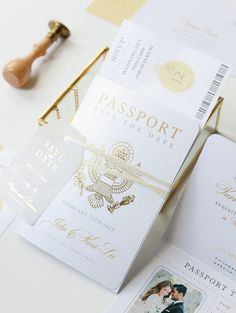 the wedding stationery is laid out on top of each other, including two passport cards