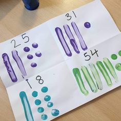 the numbers are drawn on paper with different colors and shapes to make them look like they are