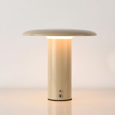 a white table lamp sitting on top of a counter