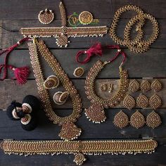 an assortment of beaded jewelry laid out on a wooden surface