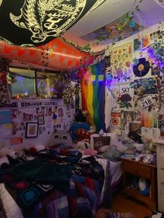 a room filled with lots of clutter and pictures on the walls, including a bed