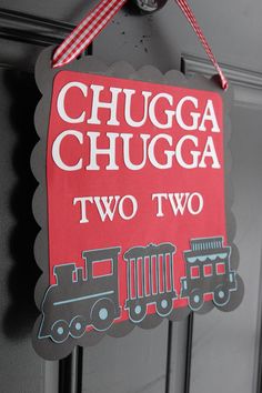 a red sign hanging from the side of a door that says chuga chuga two two