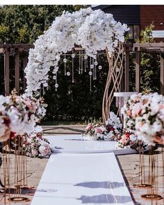 an outdoor ceremony setup with flowers and candles