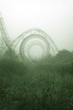 an amusement park in the fog with a roller coaster on it's side and text that reads, narra dreamland, oregon park rozywki w japan