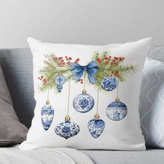 blue and white christmas ornaments hanging on a tree branch throw pillow by creativeempore