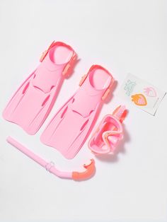 two pink children's swimming suits and accessories on a white surface