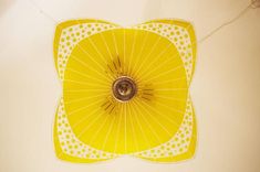 a yellow parasol hanging from the ceiling