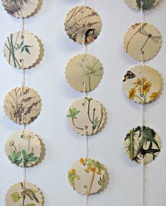 a bunch of tags that are hanging on a wall with flowers and birds in them