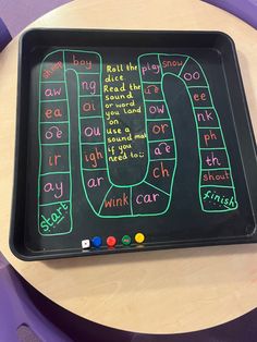 a black tray with writing on it sitting on a table