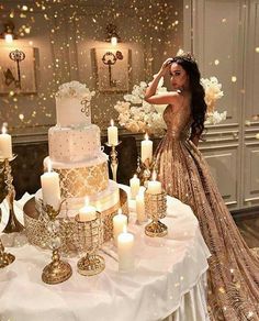 a woman standing next to a table with candles