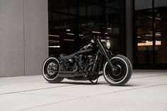 a black motorcycle parked in front of a building