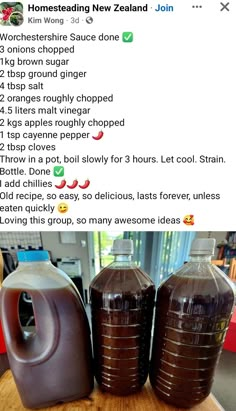 two jugs of chocolate syrup sitting on top of a wooden table next to each other