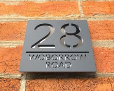 a sign on the side of a brick building that reads 28 wobotrow road