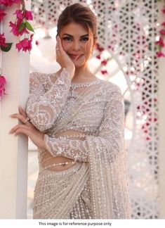 Bollywood Replica SareeBollywood Jacqueline Fernandez-inspired net white sareeSaree in net fabric with fancy thread work and sequins work with satin inner and blouse in net fabric with fancy work as unstitch material with satin inner.Shipping time is 5-7 days.Buy this Saree at Kollybollyethnics and make your occasion very special !!. With Express Free Shipping and Custom Stitching, Shop Bollywood Jacqueline Fernandez inspired net white saree at kollybollyethnics from India with free worldwide sh Saree With Full Sleeve Blouse, Pearl Work Saree, Net Saree Blouse Designs, Net Saree Blouse, Indian Bridal Sarees, Full Sleeve Blouse, Blouse Designer, Fancy Sarees Party Wear, White Saree