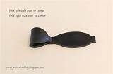 a black spoon sitting on top of a white table