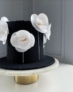 a black hat with white flowers on it