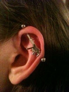 a person with some piercings on their ear and one in the other's ear