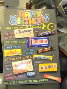 a birthday sign is decorated with candy bars and writing on it that says, happy birthday 50 now that you've reached the crunch