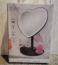 a box with a heart shaped lamp in it