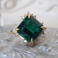 Read about our payment plans before proceeding. "Tears of Beauty: Her Highness Emerald Diamond Ring" Have you ever laid eyes on something so exquisite that it moved you to tears? Meet the Her Highness Emerald Diamond Ring, a masterpiece of unparalleled beauty. This exceptional ring features an exquisite emerald, a gemstone known for its luscious and captivating color that can leave anyone in awe. The emerald's verdant beauty is framed by a brilliant ensemble of white diamonds and baguette diamon Emerald Gemstone Ring, Sparkle Accessories, Morganite Diamond Ring, Emerald Ring Vintage, Emerald Rings, Green Emerald Ring, Wedding Promises, Morganite Diamond, Emerald Diamond Ring