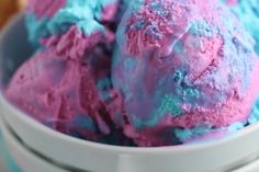 three scoops of blue and pink ice cream in a bowl