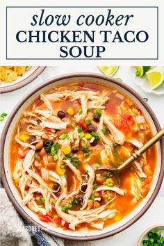 slow cooker chicken taco soup in a bowl with a spoon and cilantro on the side