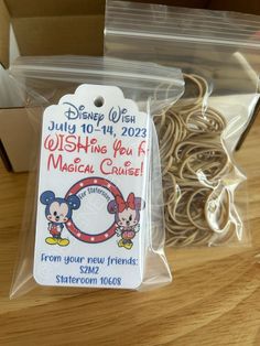 a package of mickey mouse rubber bands for sale on a table with other items in the background